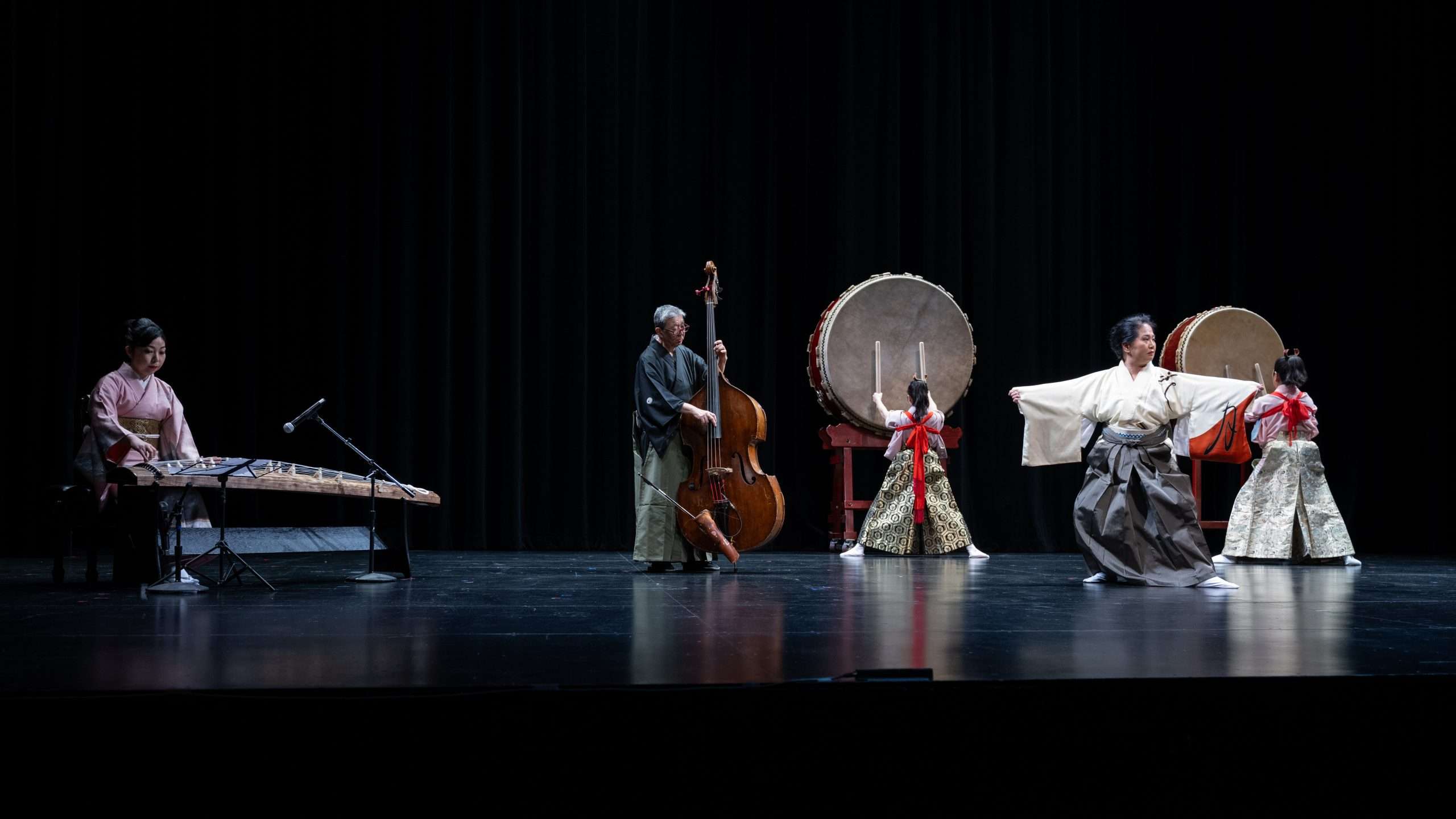 Four musicians and a dancer on stage